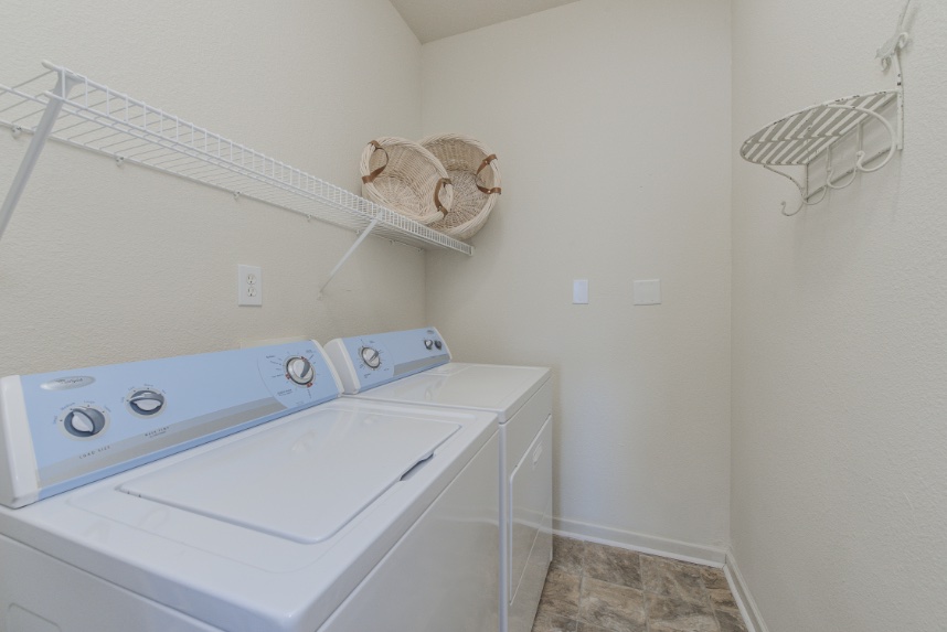 Laundry room with storage space in Sylvania.